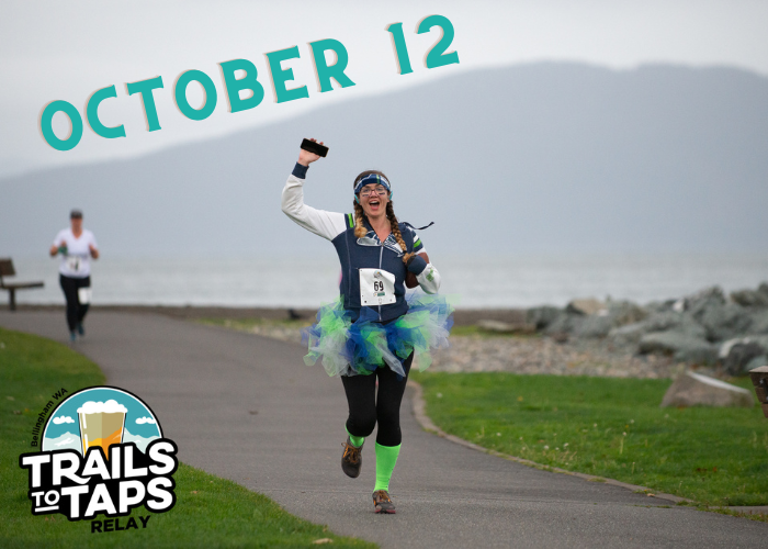 Runner in Seahawks outfit runs along waterfront